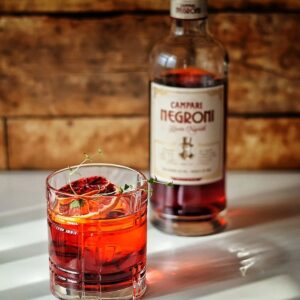 Any tumbler negroni next to campari flask